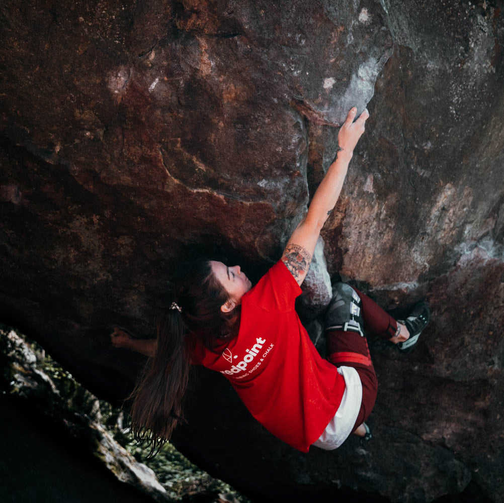 female wearing redpoint climbing teeshirt in classic red contoured fit bouldering in mount macedon
