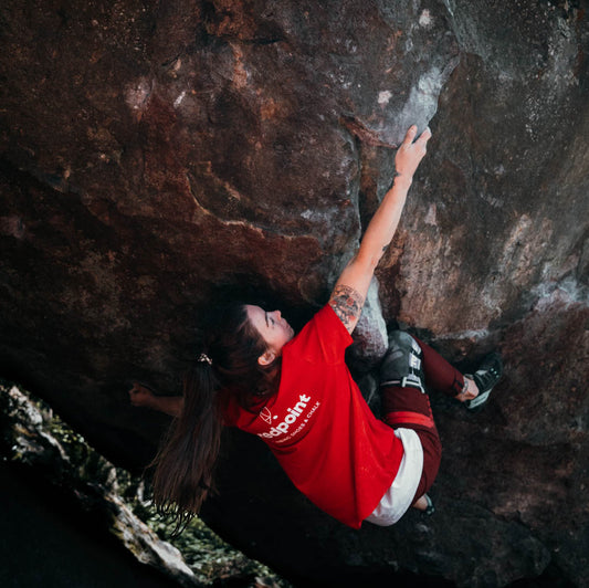 female wearing redpoint climbing teeshirt in classic red contoured fit bouldering in mount macedon