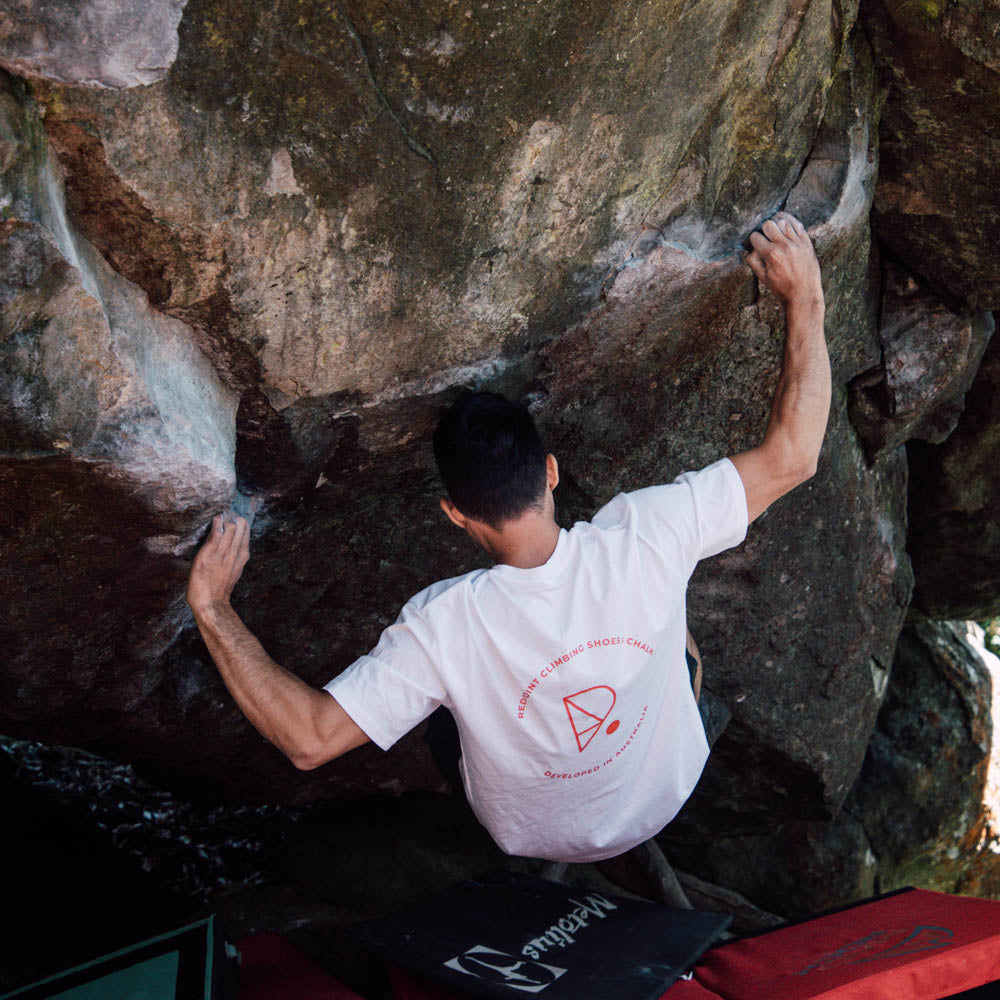 male wearing redpoint climbing organic teeshirt in white straight fit bouldering in mount macedon