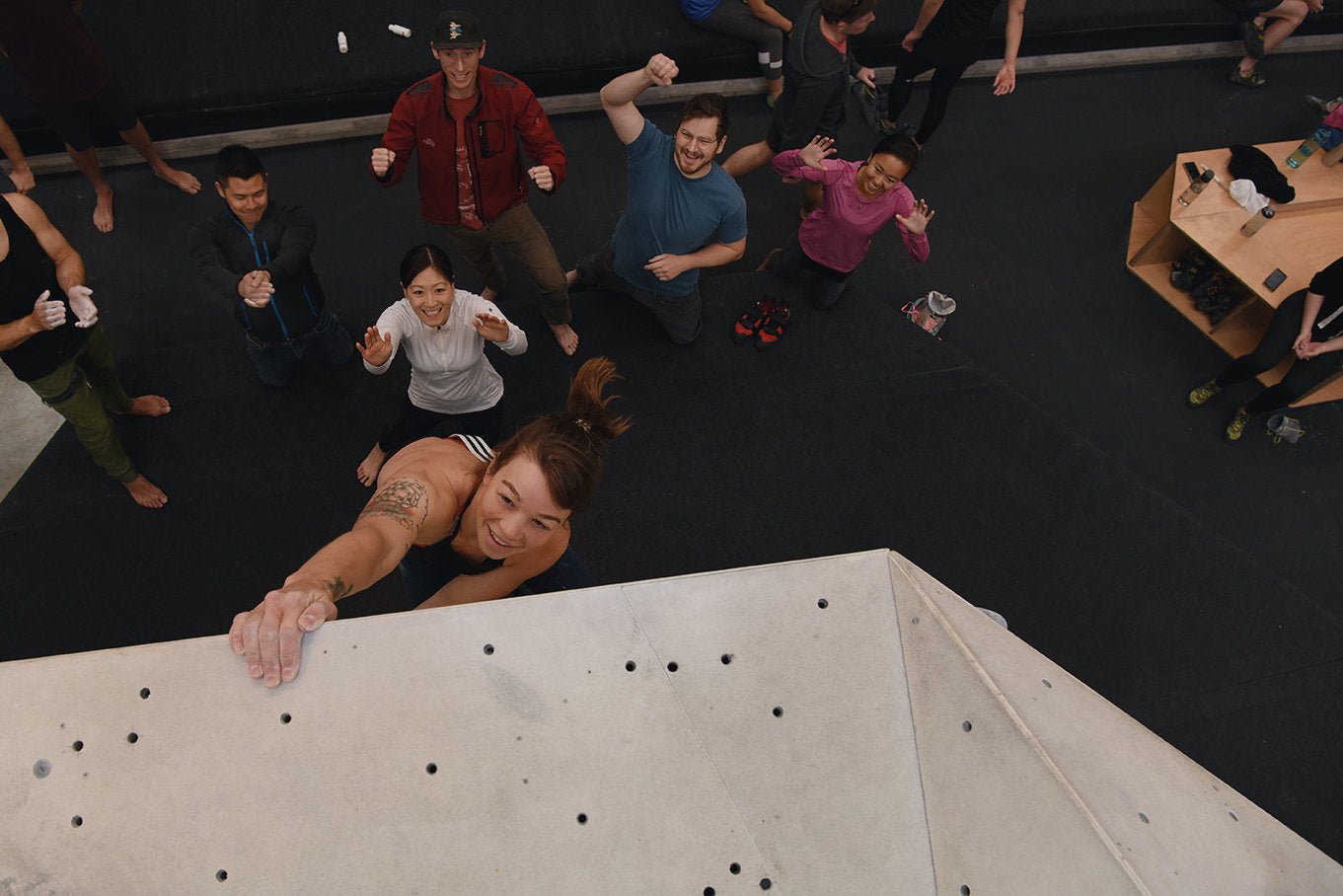 Stef Kujawa toping out on a bouldering route at Urban Climb Collingwood